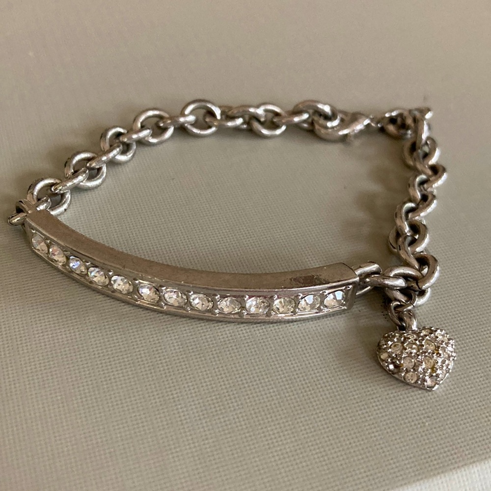 Crystal rhinestone bracelet with heart encrusted rhinestone hang charm.